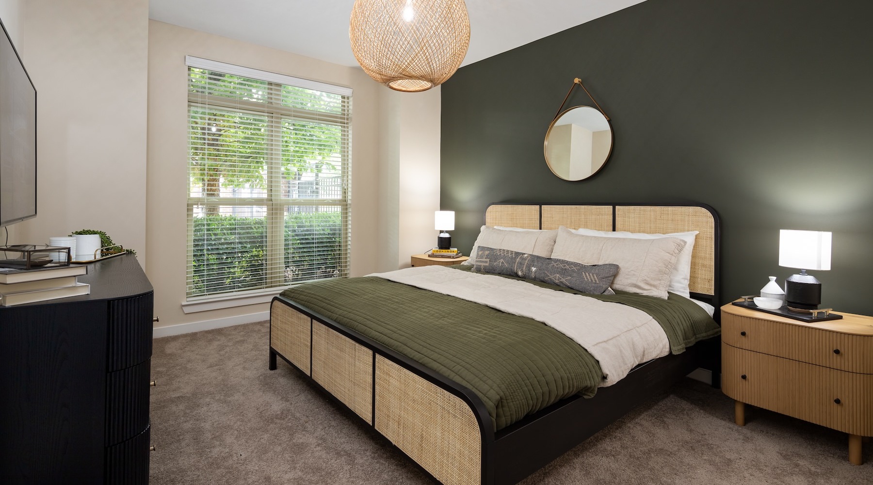 a large bedroom with lamps and a large window