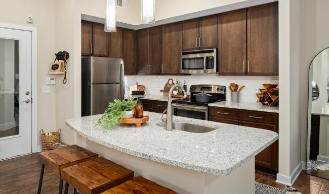 a kitchen with a marble counter top