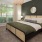a bedroom with a bed and a mirror
