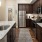 a kitchen with dark wood cabinets